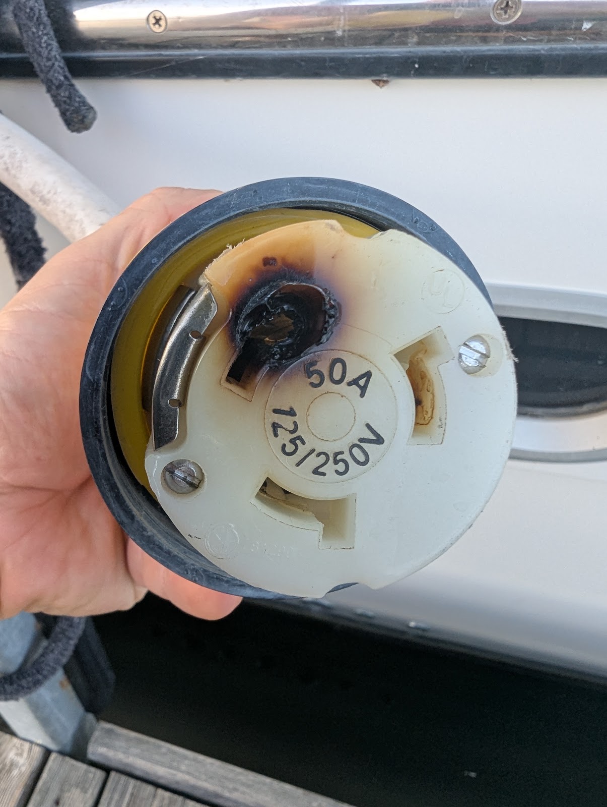 Charred contact and damaged plastic on the old 50 A female shore-power connector